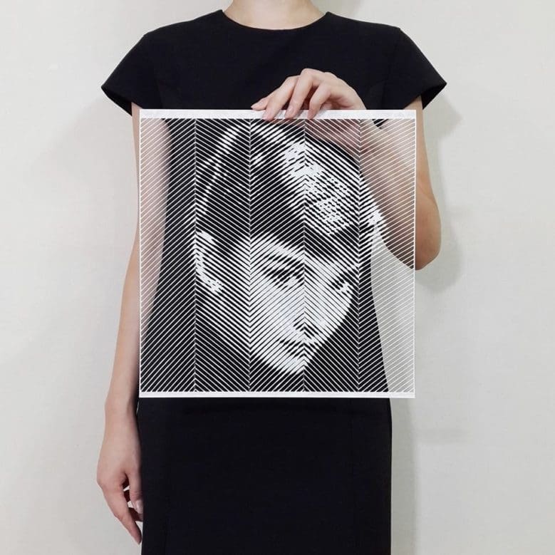 Artist hand-cuts paper to create hyperrealistic portraits of famous icons